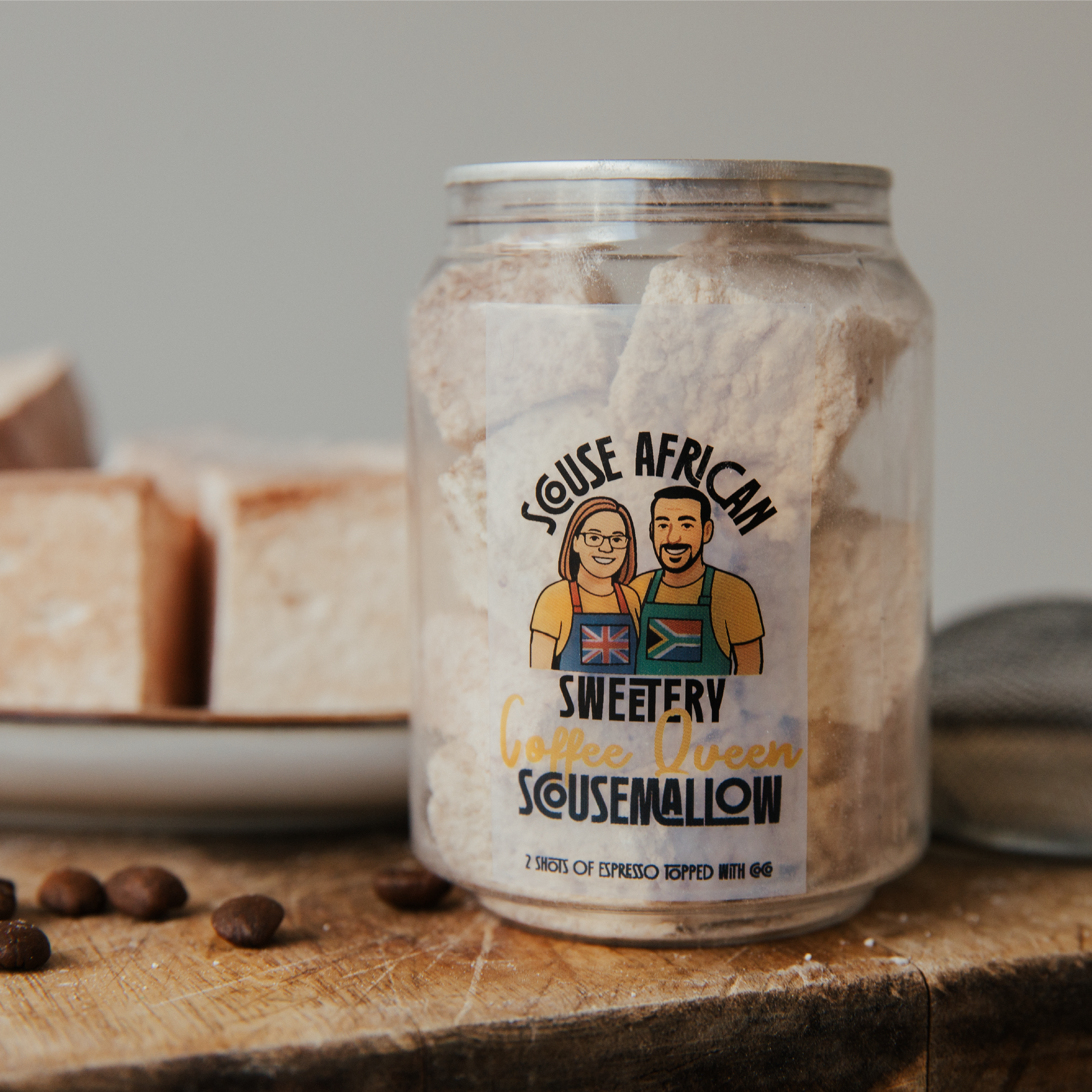 Jar of 'Scouse African' Coffee Queen marshmallows with a label featuring two people on a wooden surface.