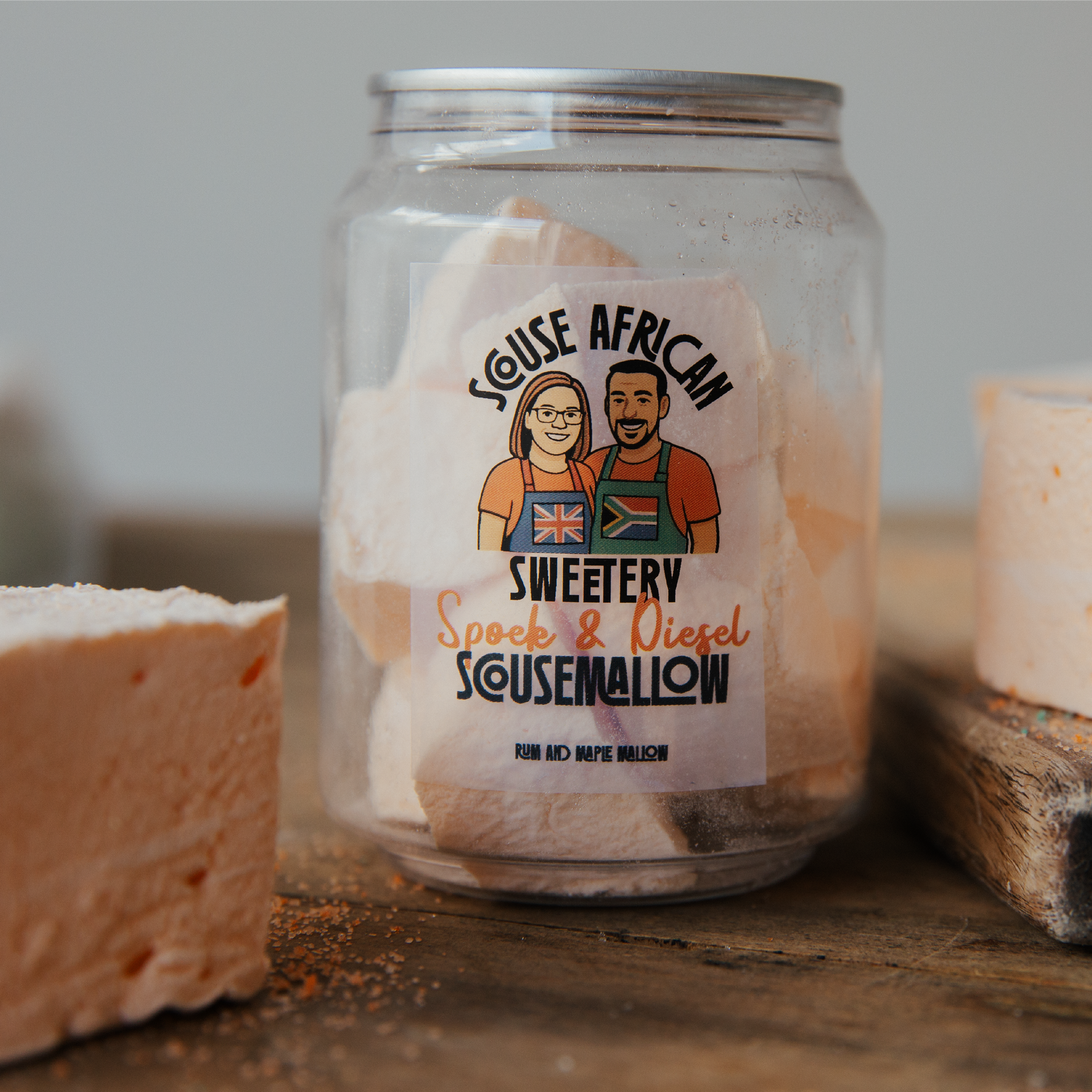 Can of marshmallows with a label featuring two people and text, on a wooden surface.