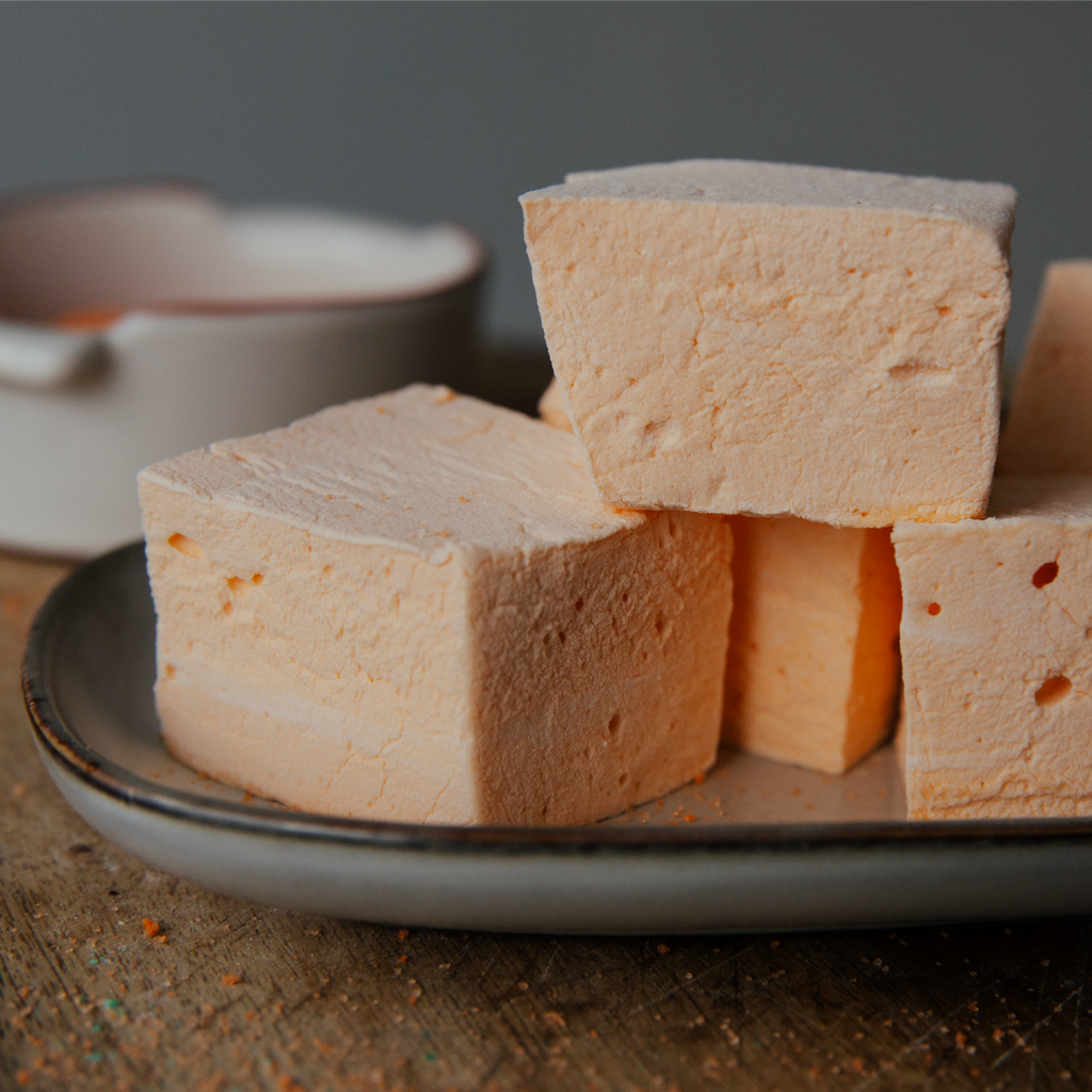 Cubes of marshmallow on a plate with a blurred background
